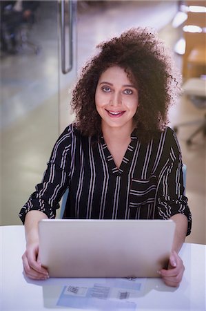 simsearch:6113-08568652,k - Portrait smiling, confident businesswoman working at laptop Stock Photo - Premium Royalty-Free, Code: 6113-09005000