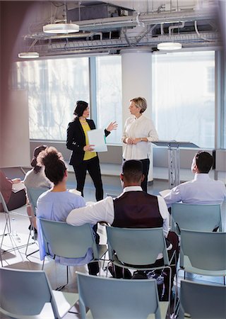 simsearch:6113-08550005,k - Businesswomen talking, leading conference presentation Stock Photo - Premium Royalty-Free, Code: 6113-09005008