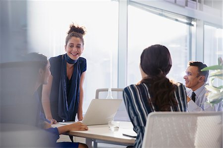 Businesswoman at laptop leading conference room meeting Stock Photo - Premium Royalty-Free, Code: 6113-09005015