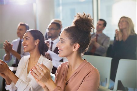 simsearch:6113-09004919,k - Businesswomen clapping in conference audience Fotografie stock - Premium Royalty-Free, Codice: 6113-09005028