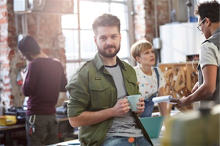 simsearch:6113-09005207,k - Portrait confident young male designer drinking coffee in workshop Stock Photo - Premium Royalty-Free, Code: 6113-09005170