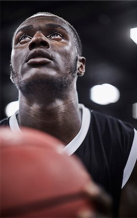 simsearch:6113-09005110,k - Close up focused young male basketball player with basketball looking up Stock Photo - Premium Royalty-Free, Code: 6113-09005127