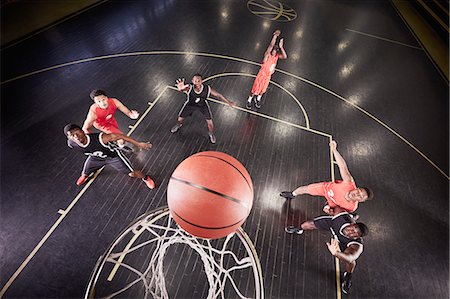 simsearch:6113-09005088,k - Overhead view young male basketball player shooting free throw in basketball game Stock Photo - Premium Royalty-Free, Code: 6113-09005133