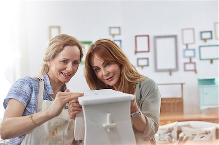 portrait of smiling two women - Female artists painting wooden bench in art class workshop Stock Photo - Premium Royalty-Free, Code: 6113-09005264