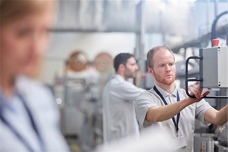 simsearch:6113-07160305,k - Male worker using machinery control panel in factory Stock Photo - Premium Royalty-Free, Code: 6113-09005343