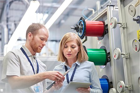 factory - Male and female workers with digital tablet examining part in fiber optics factory Stock Photo - Premium Royalty-Free, Code: 6113-09005314