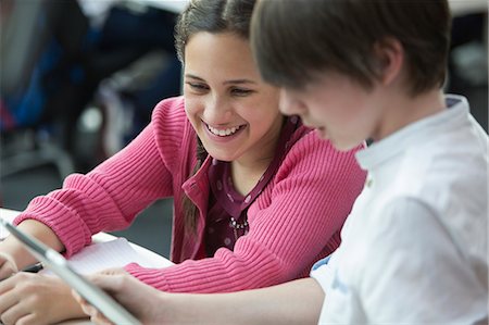 simsearch:6113-07243306,k - Smiling students using digital tablet in classroom Stock Photo - Premium Royalty-Free, Code: 6113-09027275