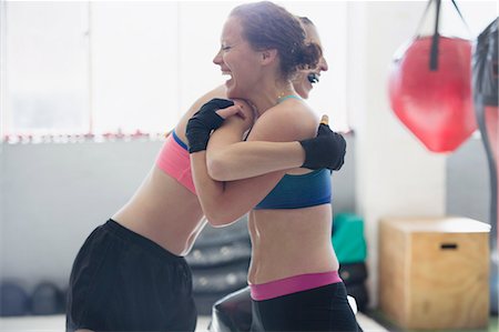 simsearch:649-09230700,k - Smiling female boxers hugging in gym Stock Photo - Premium Royalty-Free, Code: 6113-09027317