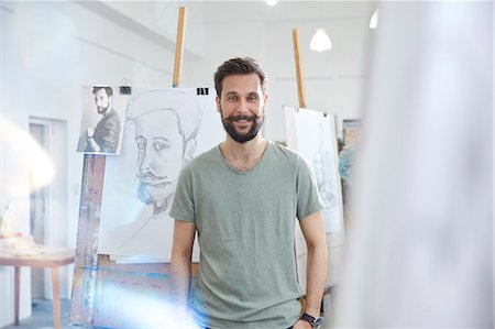 easel - Portrait smiling, confident male artist sketching in art class studio Stock Photo - Premium Royalty-Free, Code: 6113-09027443