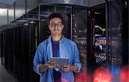 simsearch:6122-07706946,k - Portrait confident male IT technician with digital tablet in server room Stock Photo - Premium Royalty-Free, Code: 6113-09027556