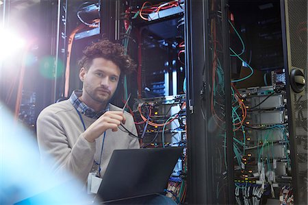 stubble - Portrait confident male IT technician working at laptop in server room Stock Photo - Premium Royalty-Free, Code: 6113-09027588