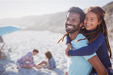simsearch:6113-07565150,k - Smiling, affectionate father piggybacking daughter on sunny summer beach Stock Photo - Premium Royalty-Free, Code: 6113-09027641
