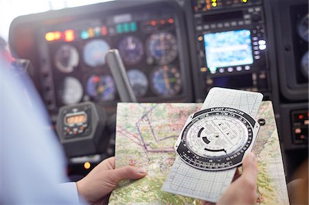 simsearch:625-00805855,k - Pilot checking navigational map and compass instrument in airplane cockpit Stock Photo - Premium Royalty-Free, Code: 6113-09027799