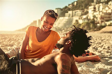 simsearch:400-07833284,k - Playful young couple relaxing on sunny summer beach Stock Photo - Premium Royalty-Free, Code: 6113-09027841