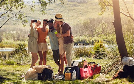 simsearch:6113-08947395,k - Young friends taking selfie with camera phone at sunny summer riverside Stock Photo - Premium Royalty-Free, Code: 6113-09027887