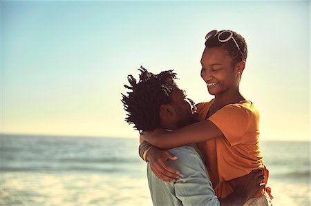 simsearch:6124-08805279,k - Affectionate young couple hugging on sunny summer beach Stock Photo - Premium Royalty-Free, Code: 6113-09027896
