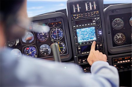 simsearch:6113-09059160,k - Male pilot using navigational instruments in airplane cockpit Photographie de stock - Premium Libres de Droits, Code: 6113-09027812