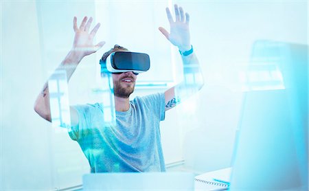 Male computer programmer testing virtual reality simulator glasses in office Stock Photo - Premium Royalty-Free, Code: 6113-09144446