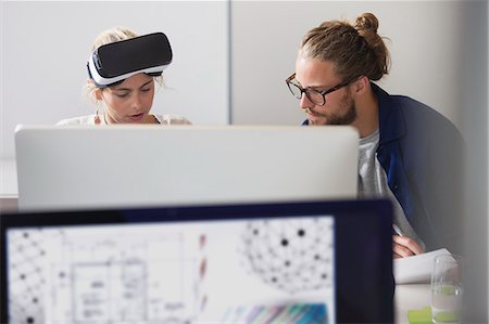 futuristic offices - Focused computer programmers programming virtual reality simulator glasses at computer in office Stock Photo - Premium Royalty-Free, Code: 6113-09144472