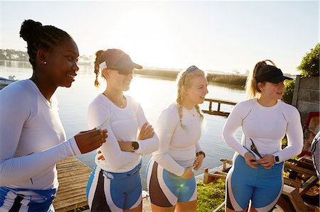 simsearch:632-05760719,k - Female rowing team standing at sunny lakeside Photographie de stock - Premium Libres de Droits, Code: 6113-09144499