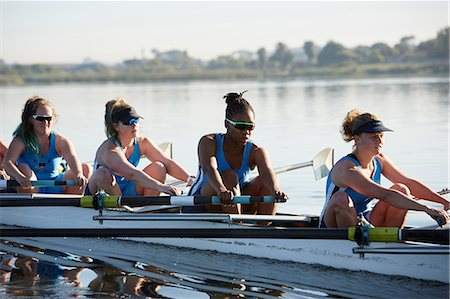 rowing boat team - Female rowers rowing scull on sunny lake Stock Photo - Premium Royalty-Free, Code: 6113-09144557