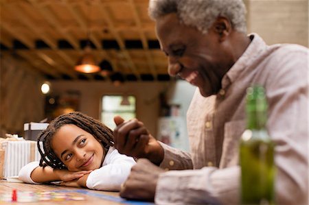 simsearch:6113-09131576,k - Smiling granddaughter and grandfather playing board game Stock Photo - Premium Royalty-Free, Code: 6113-09144614