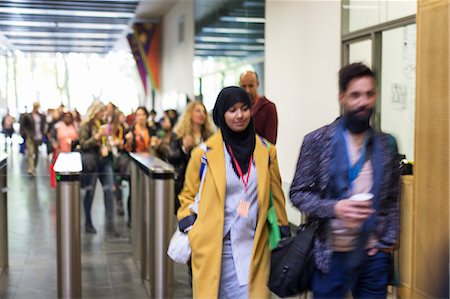 People arriving, entering turnstile at conference Fotografie stock - Premium Royalty-Free, Codice: 6113-09157384