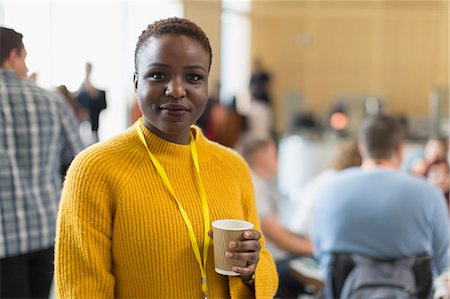 simsearch:6113-06908856,k - Portrait confident businesswoman drinking coffee at conference Foto de stock - Royalty Free Premium, Número: 6113-09157401