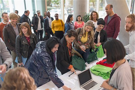 Business people arriving, checking in at conference registration table Stock Photo - Premium Royalty-Free, Code: 6113-09157405