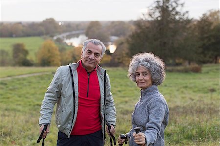 retired latino - Portrait confident active senior couple hiking in rural field Stock Photo - Premium Royalty-Free, Code: 6113-09157565