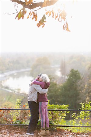 simsearch:6124-08805230,k - Affectionate active senior couple hugging in sunny autumn park Stock Photo - Premium Royalty-Free, Code: 6113-09157591