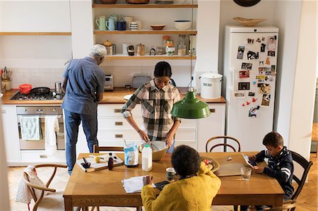 family cooking tablet - Grandparents and grandchildren baking and using digital tablet in kitchen Stock Photo - Premium Royalty-Free, Code: 6113-09157653