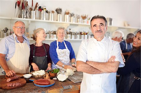 simsearch:6113-08743631,k - Portrait confident chef with senior students in cooking class kitchen Stock Photo - Premium Royalty-Free, Code: 6113-09157729