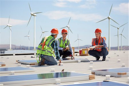 Engineers installing solar panels at alternative energy power plant Stock Photo - Premium Royalty-Free, Code: 6113-09157824