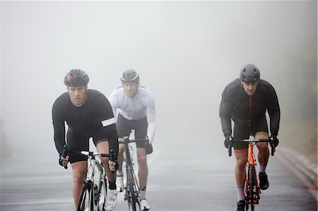 simsearch:695-03378165,k - Dedicated male cyclists cycling on rainy road Stock Photo - Premium Royalty-Free, Code: 6113-09157913