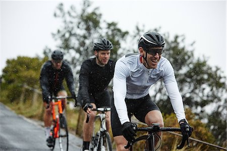 simsearch:630-06724152,k - Smiling male cyclist cycling with friends Stock Photo - Premium Royalty-Free, Code: 6113-09157931