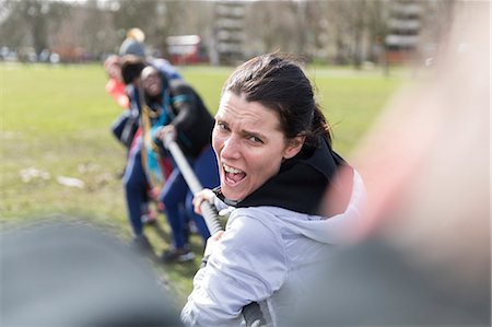 simsearch:6113-09160064,k - Determined woman enjoying tug-of-war in park Fotografie stock - Premium Royalty-Free, Codice: 6113-09160059