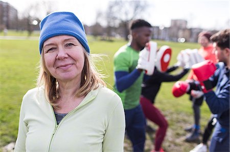 Portrait confident senior woman boxing in park Stock Photo - Premium Royalty-Free, Code: 6113-09160092