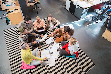 Creative business team meeting, brainstorming in circle on floor in office Stock Photo - Premium Royalty-Free, Code: 6113-09160007