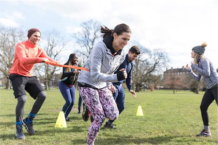 simsearch:6113-09160064,k - People racing, doing team building exercise in sunny park Fotografie stock - Premium Royalty-Free, Codice: 6113-09160180