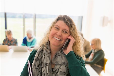 simsearch:6113-07565707,k - Smiling businesswoman talking on smart phone Stock Photo - Premium Royalty-Free, Code: 6113-09160240