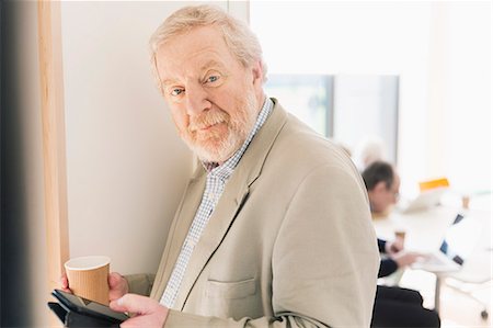 side view of senior with computer - Portrait confident senior businessman with digital tablet Stock Photo - Premium Royalty-Free, Code: 6113-09160254