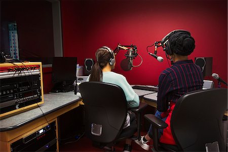 simsearch:6113-09168289,k - Teenage girl musicians recording music, singing in sound booth Stock Photo - Premium Royalty-Free, Code: 6113-09168263