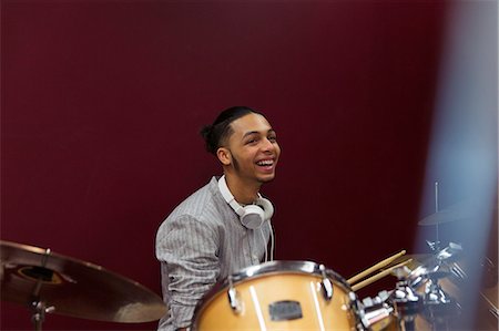 simsearch:6113-09168289,k - Happy teenage boy musician playing drums in sound booth Stock Photo - Premium Royalty-Free, Code: 6113-09168273