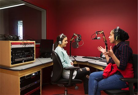 Teenage musicians recording music in sound booth Stock Photo - Premium Royalty-Free, Code: 6113-09168270