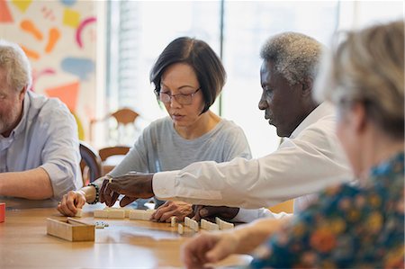 simsearch:6113-09192020,k - Senior friends playing mahjong at table in community center Stock Photo - Premium Royalty-Free, Code: 6113-09168389