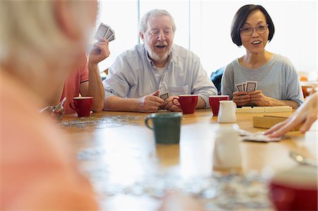 senior, playing cards - Senior friends playing games at table in community center Stock Photo - Premium Royalty-Free, Code: 6113-09168391