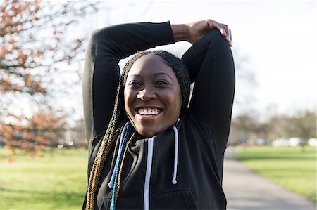 simsearch:6113-09027330,k - Portrait confident female runner stretching arms in park Fotografie stock - Premium Royalty-Free, Codice: 6113-09168321