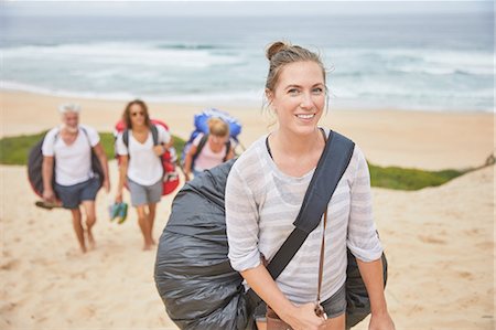 parachute, beach - Portrait smiling, confident female paraglider carrying parachute backpack on beach Stock Photo - Premium Royalty-Free, Code: 6113-09168452
