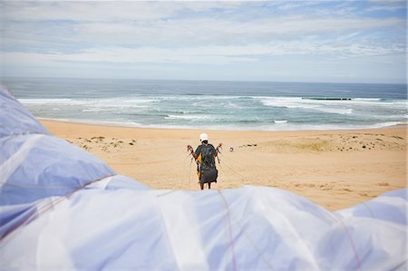 parachute, beach - Paraglider with parachute on ocean beach Stock Photo - Premium Royalty-Free, Code: 6113-09168472